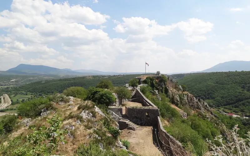 The long stone ramparts of Knin Fortress on the ridge above the town