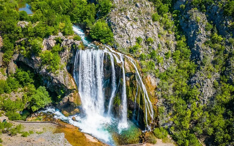 The Krčić waterfall dropping 22 metres over a green cliff into a turquoise pool near Knin